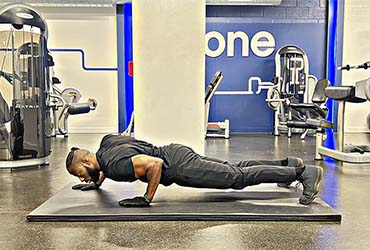 PT Demonstrating How To Perform Staggered Push Ups